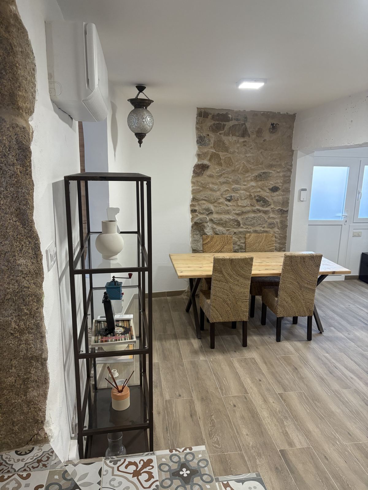 Mesa de comedor junto a un muro de granito